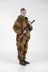 Actor man in an old military uniform and camouflage sniper marksman clothing of a soldier of the...
