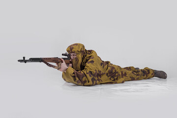 Actor man in an old military uniform and camouflage sniper marksman clothing of a soldier of the...