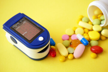 many pills, stethoscope, pulse oximeter for finger tip simultaneous monitoring of blood flow and...