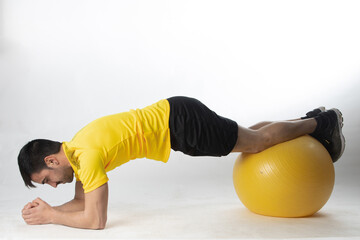 man exercising with fitball on white background