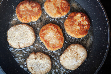 Minced beef cutlets are fried in a pan Close-up
