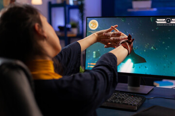Pro gamer streatching after playing live videogames use gaming equipment late at night in home studio. Online streaming cyber performing during tournament using technology network wireless © DC Studio