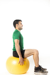 man exercising with fitball on white background