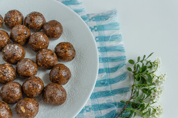 truffles with cocoa, coconut and sesame seeds with chocolate and marshmallows, delicious dessert on a white background