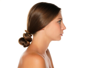 Profile of a young serious shirtless beautiful woman