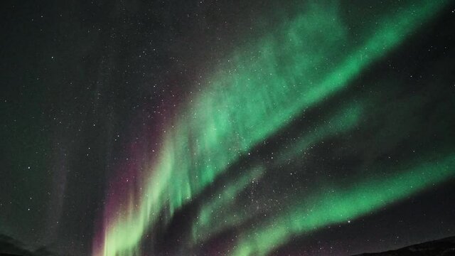 Motion Timelapse Of Aurora Borealis In The Night Sky In South Iceland. low angle shot