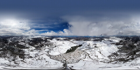 360 degree aerial shot with drone of the small town of Floresta, the highest town in Sicily, in the heart of the Nebrodi. Winter in Floresta. Snow in Sicily. View of the snow-covered Etna.