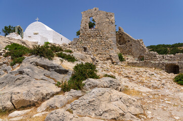 Courtyard of the Monolithos fortress with the Orthodox Church and the ruins of the tower (Rhodes, Greece)
