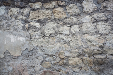 an old wall of gray stone and cement