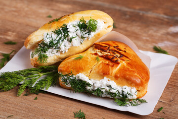 Achma - khachapuri with cheese and dill on a wooden table. Traditional Georgian cuisine.