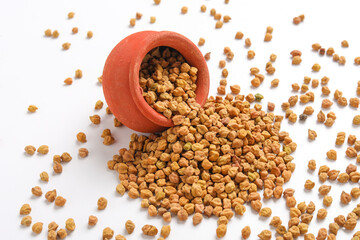 Dried chickpeas in bowl isolated on white background.