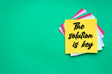 Text the solution is key on the short note texture background