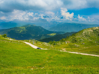 Fototapeta na wymiar The view valley in the mountains of Monte Baldo in Malcesine in Italy in a green meadow.