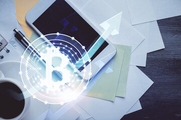 Double exposure of blockchain theme hologram over table with phone. Top view. Crypto technology...