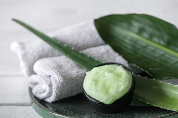 Spa composition with a natural care product with aloe and towels close up.