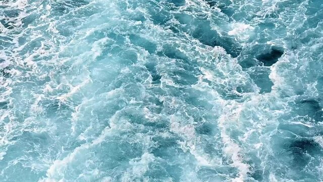 Seething blue water of the Aegean sea from a ferryboat. Slow motion. Greece
