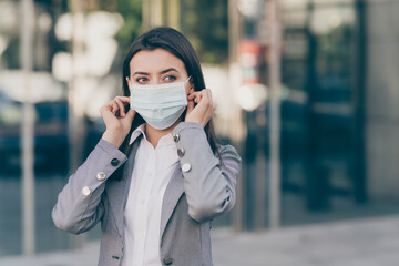 Photo of young attractive beautiful serious businesswoman in grey blazer look copyspace outside outdoors