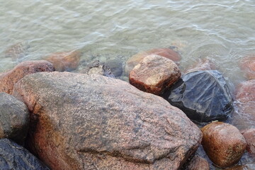 Tallinn, Estonia - 26.03.2021: Texture of stones in water during early spring