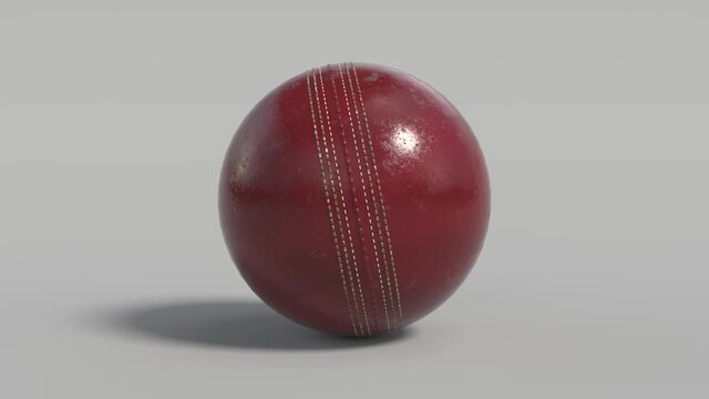 Side on view of a 3D cricket ball rolling from left to right. Shiny red cricket ball in a continuous roll perfect for sports advertising. 4K clip at 60fps for smooth motion with an alpha matte