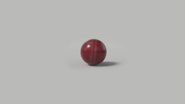 Side on view of a 3D cricket ball slowly rolling from right to left. Shiny red cricket ball in a continuous roll perfect for sports advertising. 4K clip at 30fps for smooth motion with an alpha matte