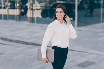 Photo of young beautiful gorgeous charming businesswoman hold laptop look copyspace go walk outside outdoors