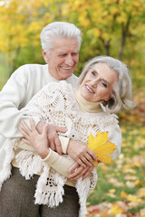 portrait of beautiful senior couple embracing   in the park