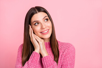 Portrait of brunette optimistic girl hands head look empty space wear pink sweater isolated on crimson color background