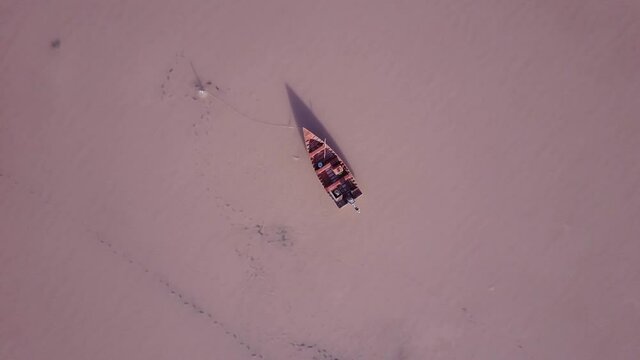 Aerial view above a boat on Lake Urmia, salt lagoon in Iran - screwdriver, drone shot