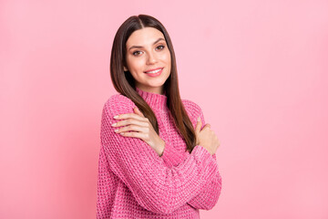 Fototapeta premium Photo of funny adorable young lady wear knitted pullover embracing herself smiling isolated pink color background