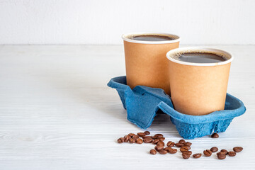 Roasted beans and take away coffee in paper cup