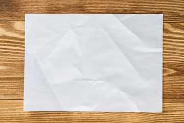 Flat lay wooden table with paper sheet