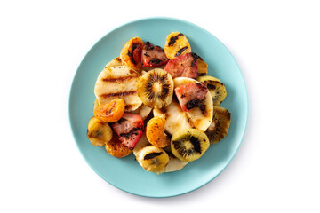 GRILLED FRUIT on a blue plate isolated on white background. Top view