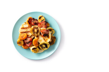 GRILLED FRUIT on a blue plate isolated on white background. Top view. Copy space