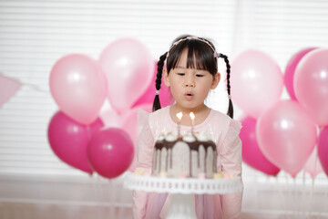 Fototapeta na wymiar young girl celebrating her 4 years birthday at home