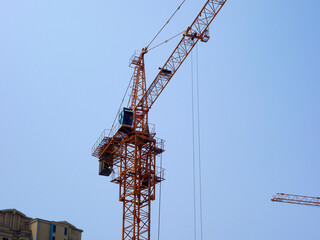 The tower crane on the construction site is busy working
