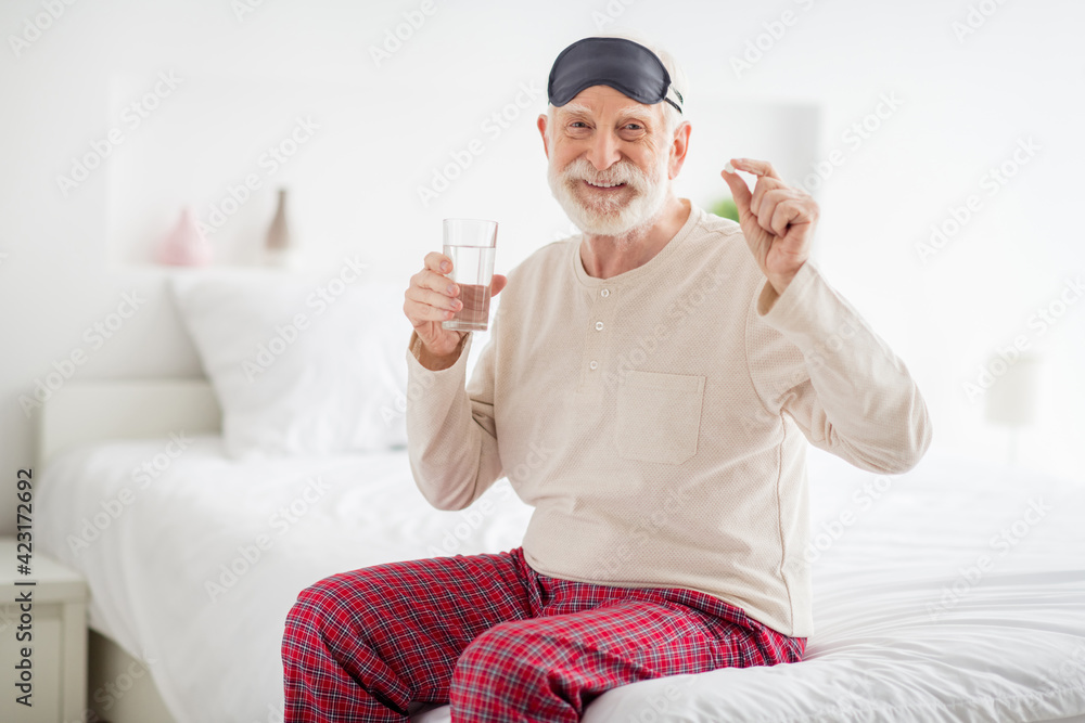 Sticker Photo of pretty attractive age pensioner sleepwear sitting bed drinking water medicine inside indoors home room