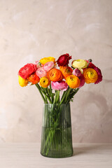 Beautiful fresh ranunculus flowers in vase on white table