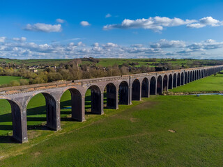 Fototapeta na wymiar A view across the Welland Valley viaduct towards the village of Harringworth on a bright sunny spring day in the UK