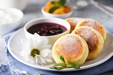 Aromatic vanilla cheesecakes with raspberry jam and sour cream for breakfast
