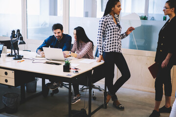 Diverse colleagues working on project together in office