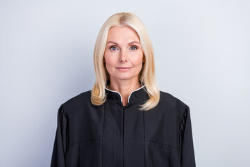 Fototapeta premium Portrait of attractive clever smart woman judge wearing black robe career promotion isolated over grey pastel color background