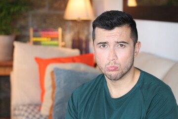 Discontented young man at home