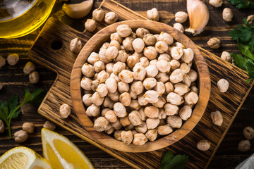 Chickpeas in white bowl at light kitchen table.