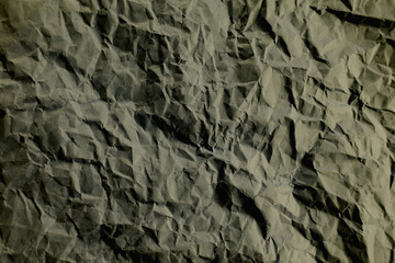 Top view photo of Crumpled craft paper. Grey color Paper background with copyspace. Vintage paper canvas texture abstract background.