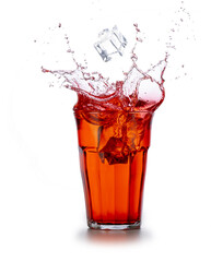 Ice cube falling into a red beverage splashing on white background.