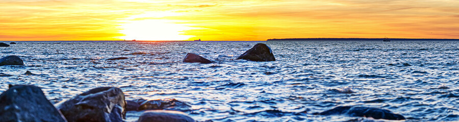 Sunset at Baltic sea stone shore, in Estonia, Viimsi. View over Baltic sea with stones to beautiful sunset