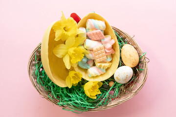 Yellow Easter chocolate egg full of candies. 