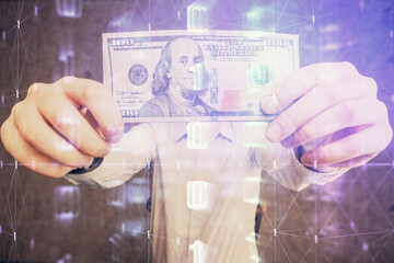 Double exposure of technology drawing hologram and us dollars bills and man hands. Data concept