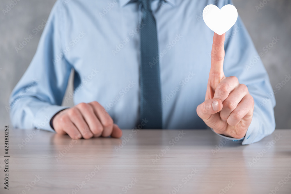 Wall mural Businessman in shirt holding heart icon symbol