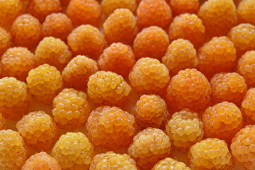 Fresh yellow raspberries background closeup photo. Top view. Pattern